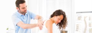 chiropractor treating womans back pain