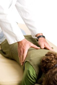 chiropractic adjustment on woman's back